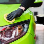 45835178 hard wax for protection paintwork of car using sponge for remove paint scratches applying hard wax with a yellow sponge protection of paintwork