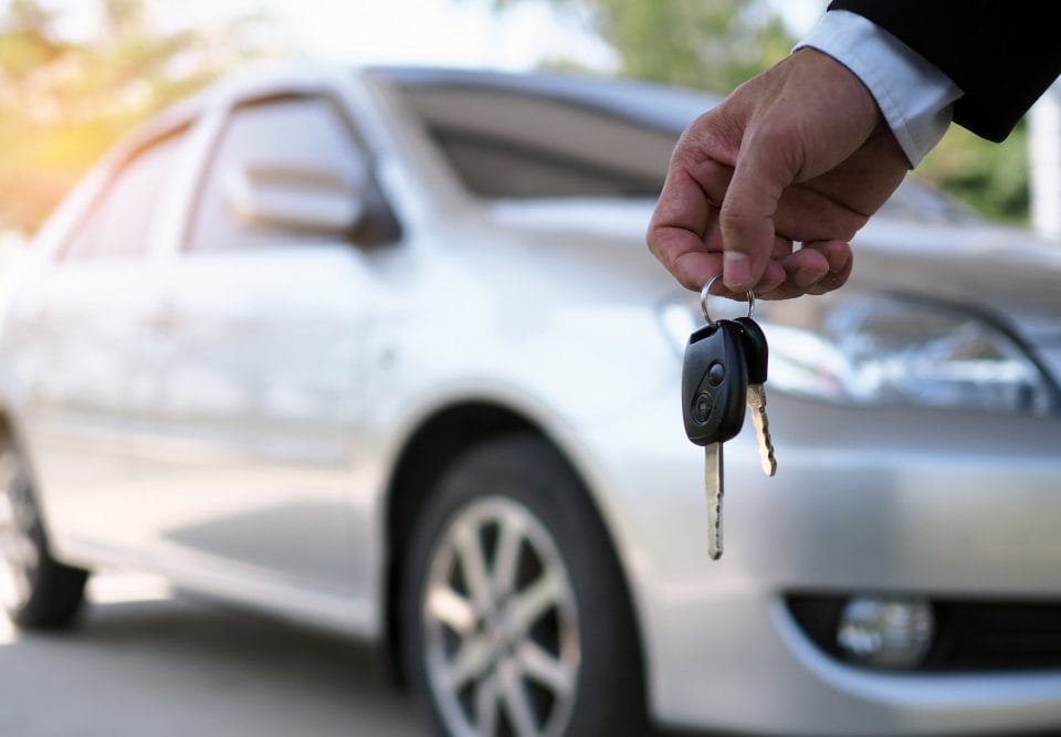 car owner is standing car keys buyer used car sales